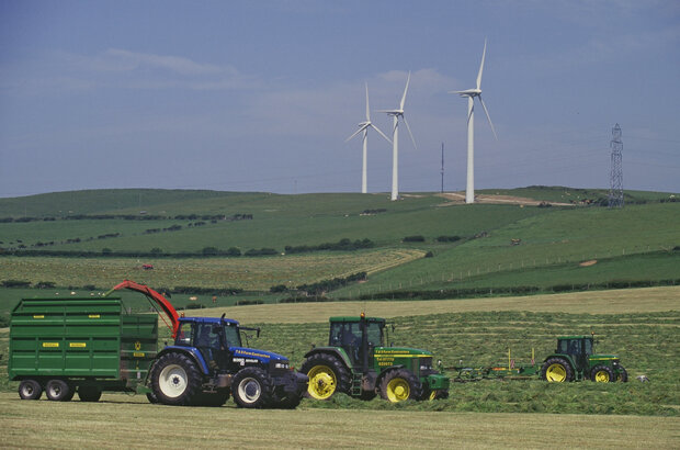 Cutting silage near wind farm Askham in Furness Cumbria