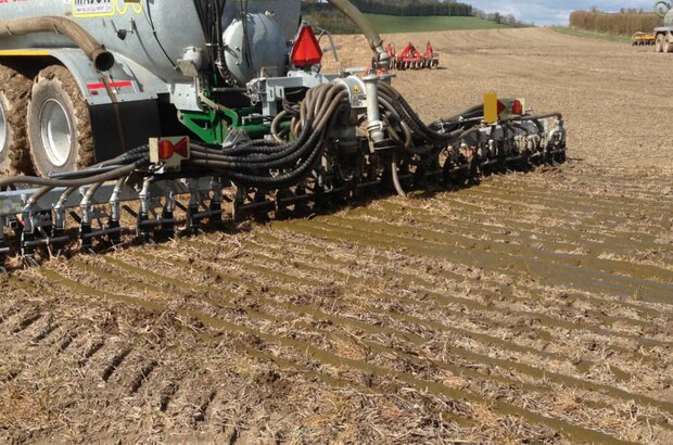 Application of slurry with a trailing shoe.