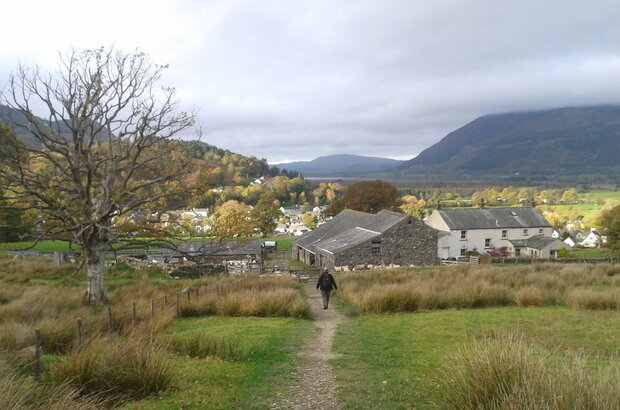 Figure walking towards farm in Cumbria