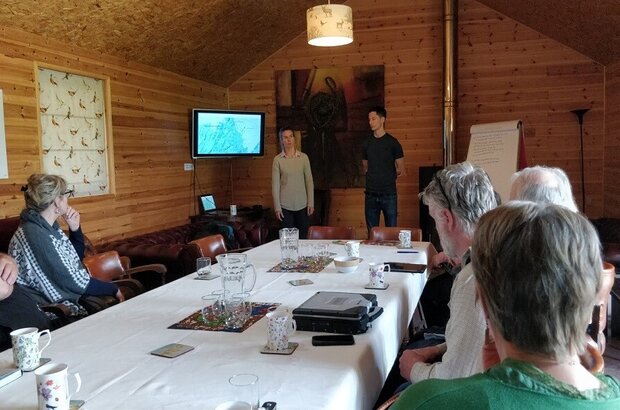 A group of farmers in a tests and trials discussion led by the facilitator