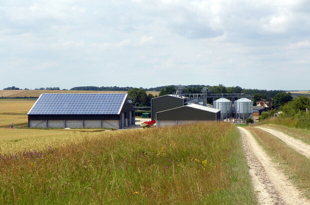 Solar panels on roof of a farm building in English farmland