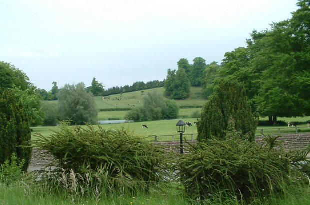 View of the estate with livestock grazing in background amid generally verdant scene.