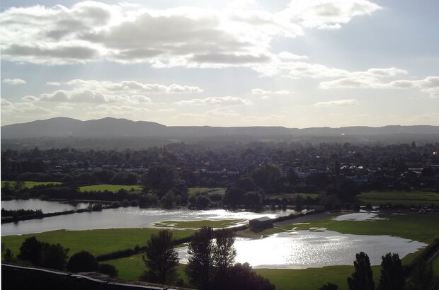 Looking south-west from the top of Worcester Cathedral Tower, it shows flooded meadows and fields on the far side of the River Severn.
