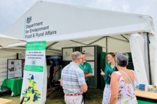 Cindy Hughes and Giles Hall talking to show attendees in front of the Defra stand