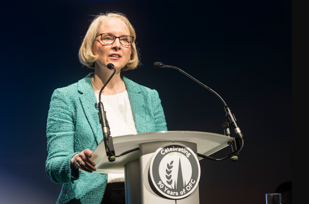 Secretary of State for Environment, Food and Rural Affairs standing at lectern speaking at OFC26